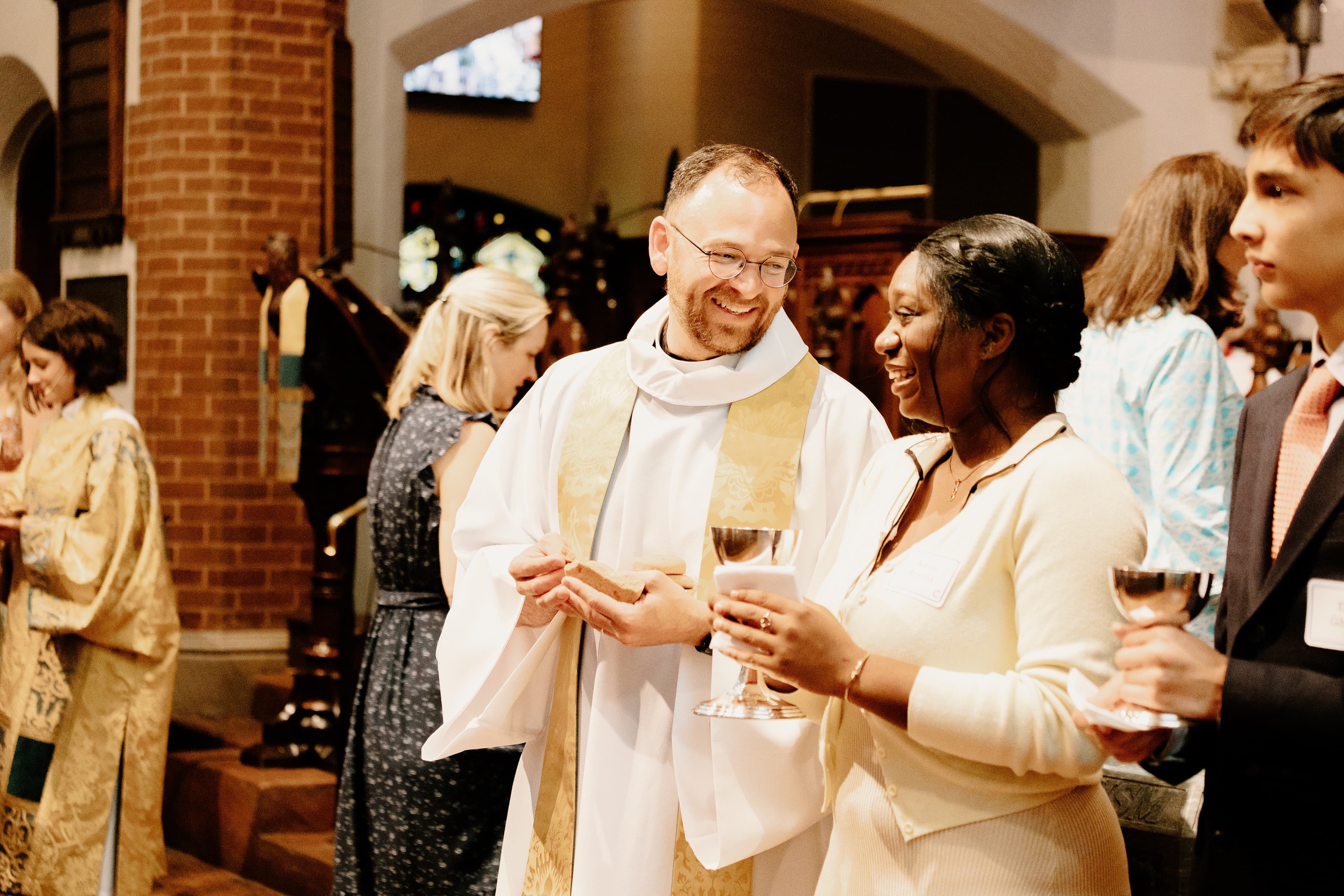 Priest and volunteer distributing communion